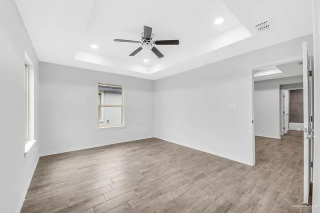 a bathroom with a granite countertop sink a toilet and a large mirror
