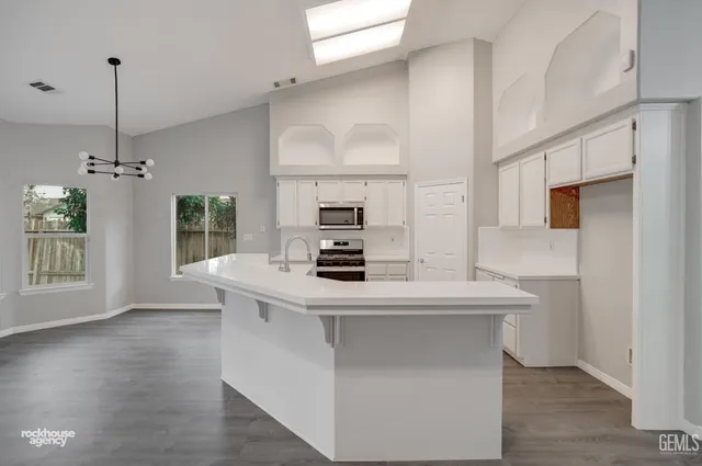 a kitchen with granite countertop a stove and a sink