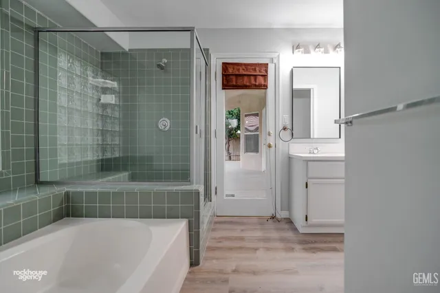 a bathroom with a bathtub and a shower