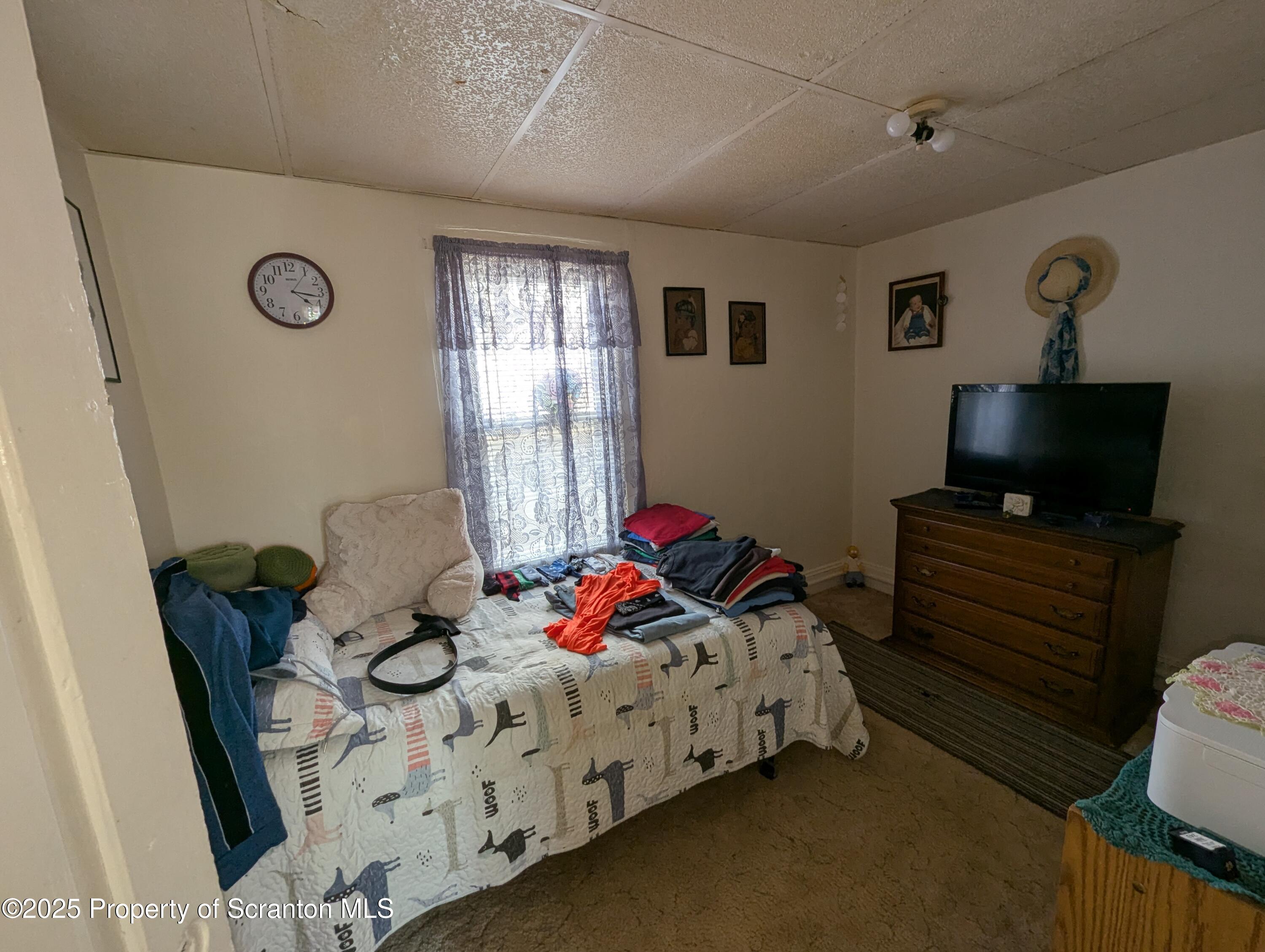846 Capouse Avenue Scranton, PA 18509 - Photo 29 of 35 a bedroom with a bed and wooden floor