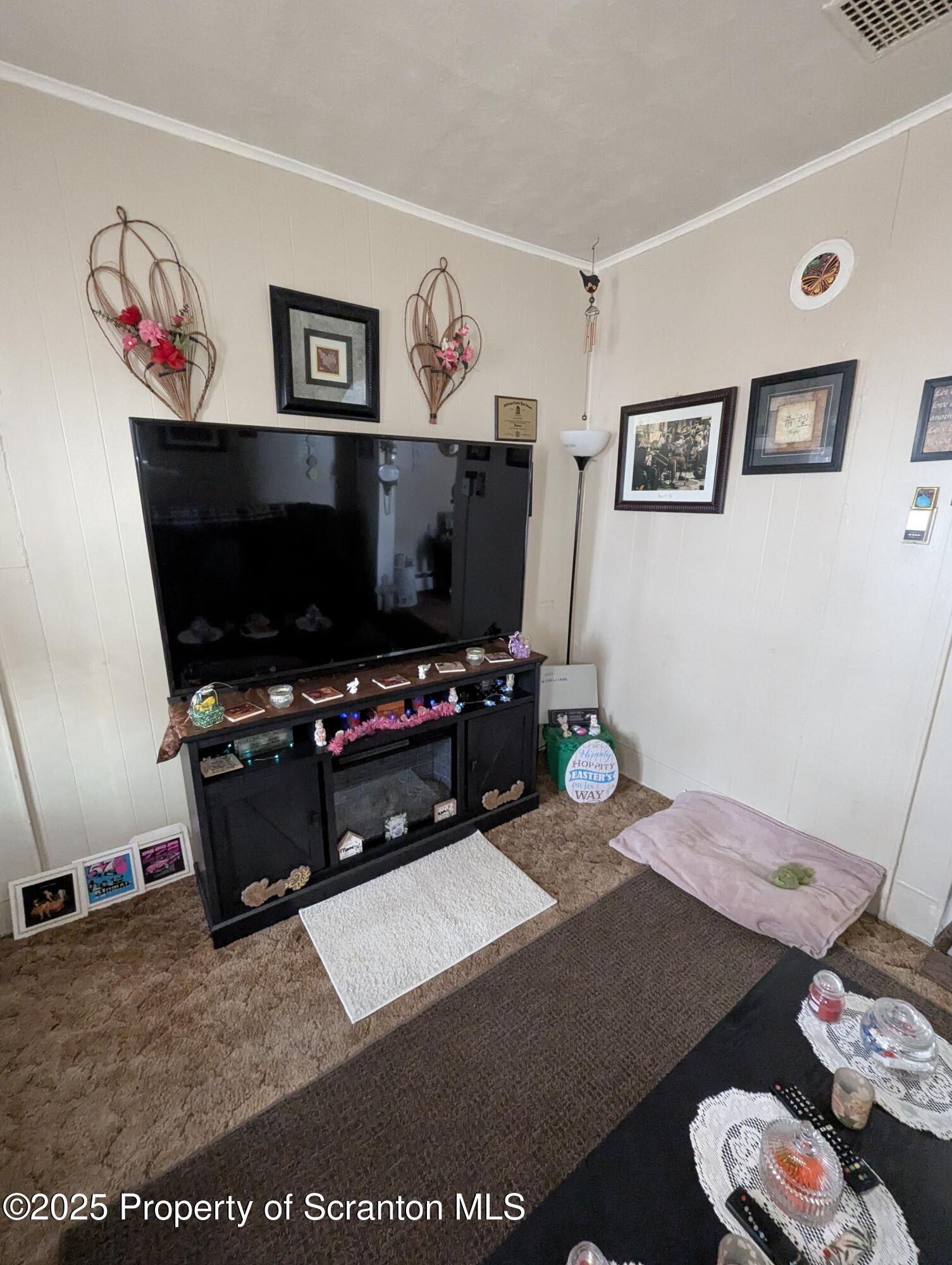 846 Capouse Avenue Scranton, PA 18509 - Photo 32 of 35 a living room with furniture and a flat screen tv
