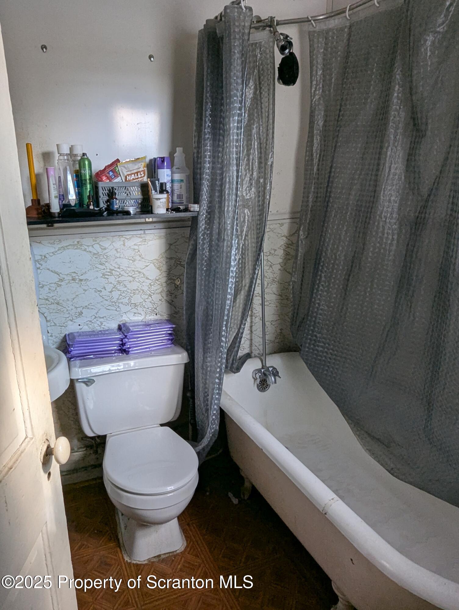 846 Capouse Avenue Scranton, PA 18509 - Photo 8 of 35 a white toilet sitting next to a bath tub