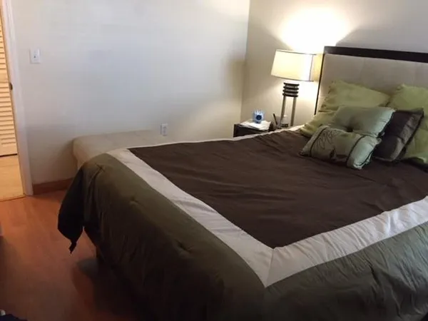 a bed sitting in a bedroom and lamp