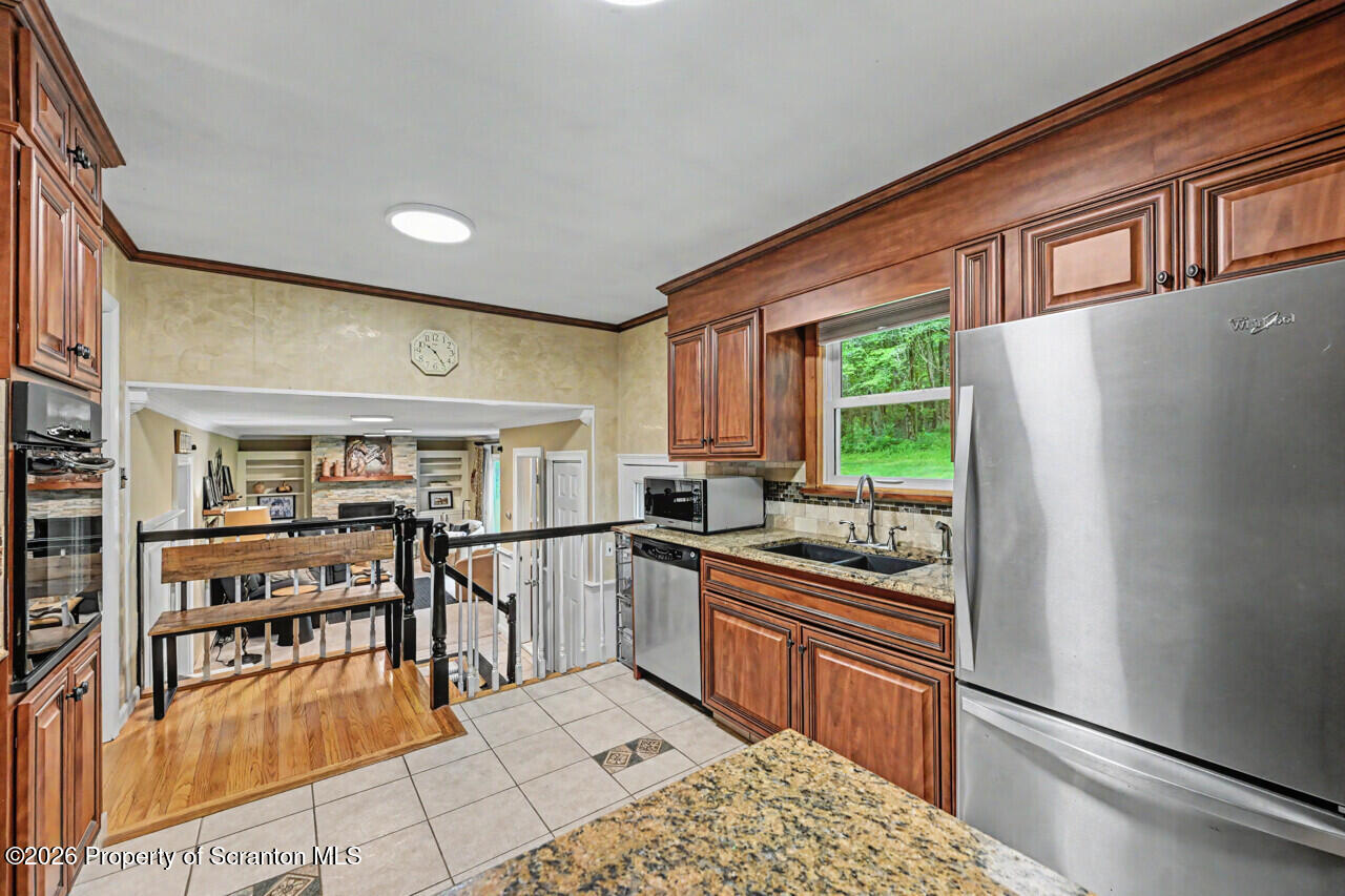 121 T Rt 351 Moscow, PA 18444 - Photo 26 of 79 a kitchen with stainless steel appliances granite countertop a refrigerator and a stove top oven