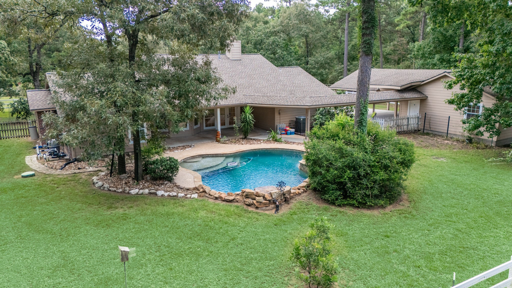 20203 Timber Ridge Drive Magnolia, TX 77355 - Photo 48 of 49 Surrounded by mature trees for exceptional privacy, this resort-style outdoor space features a sparkling freeform pool.