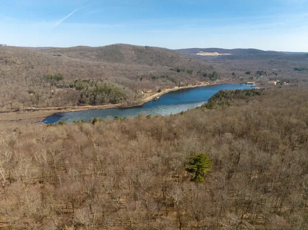 a view of a dry yard with mountains in the background