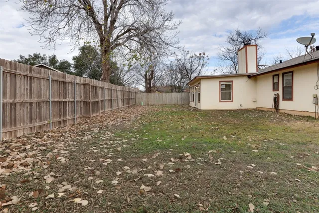 a view of a backyard with large trees