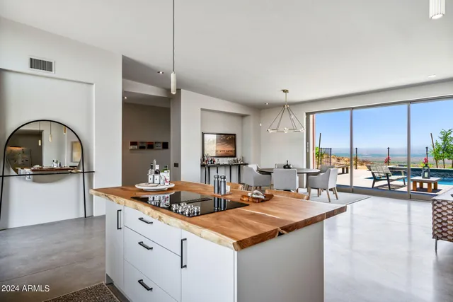 a bedroom with a large bed and a balcony view