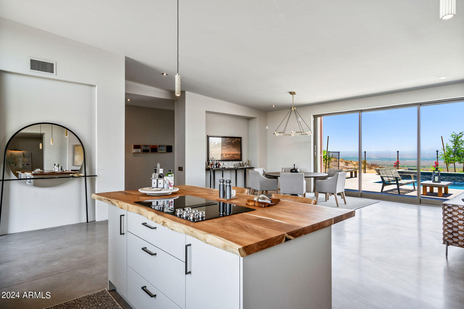 15322 North Sandy Blf Road Fort McDowell, AZ 85264 - Photo 12 of 65 a living room with stainless steel appliances kitchen island granite countertop a table chairs in it and a wooden floor