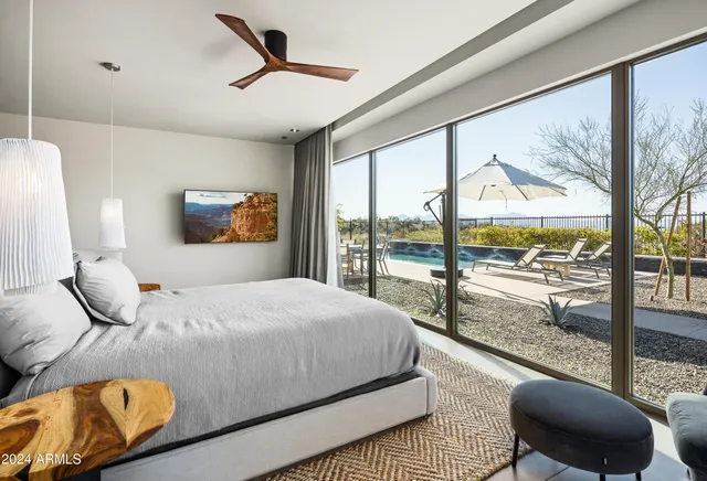 a bedroom with a bed and a chandelier