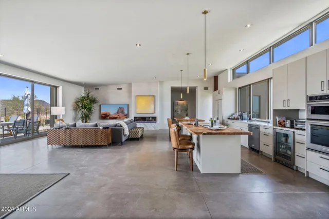 a living room with furniture a window and kitchen view