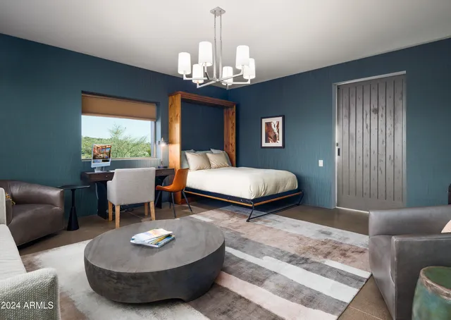 a bedroom with a large bed and a window