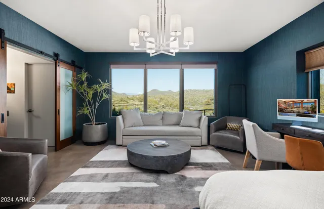 a bedroom with two beds and a large window