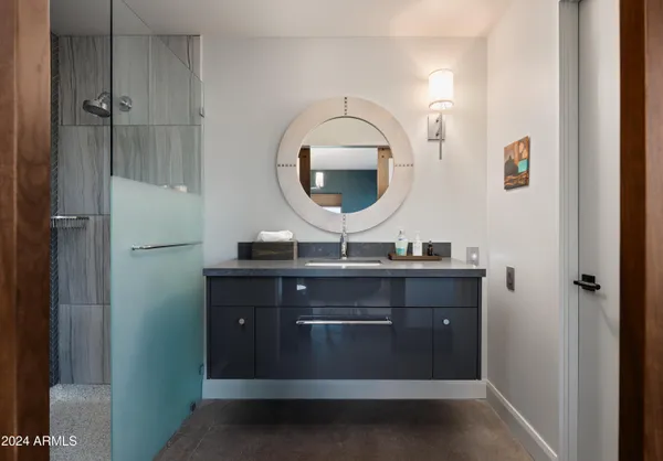 a bedroom with a bed and a lamp