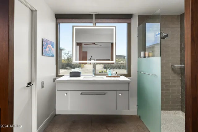 a bed room with a bed window and a table in it