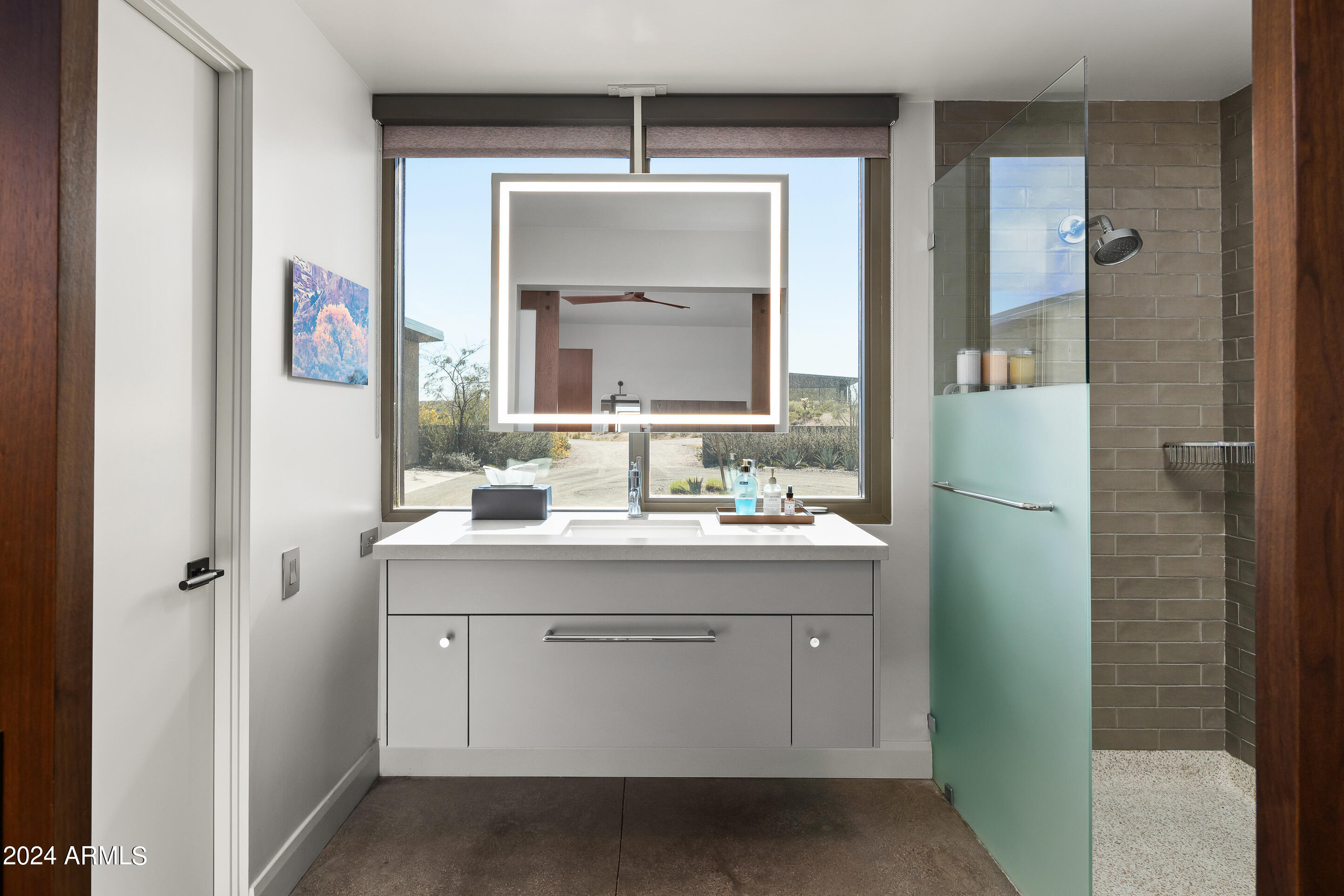 15322 North Sandy Blf Road Fort McDowell, AZ 85264 - Photo 29 of 65 a bathroom with a sink a mirror a vanity and a shower