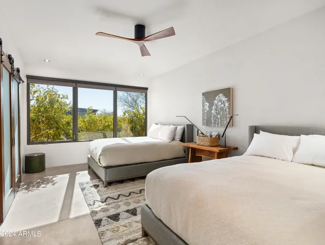 a spacious bedroom with a bed and a window