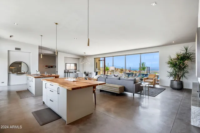 a view of living room with kitchen island furniture and a chandelier