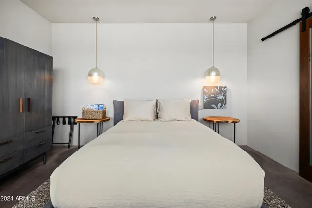 a view of a patio with couches table and chairs under an umbrella with wooden floor