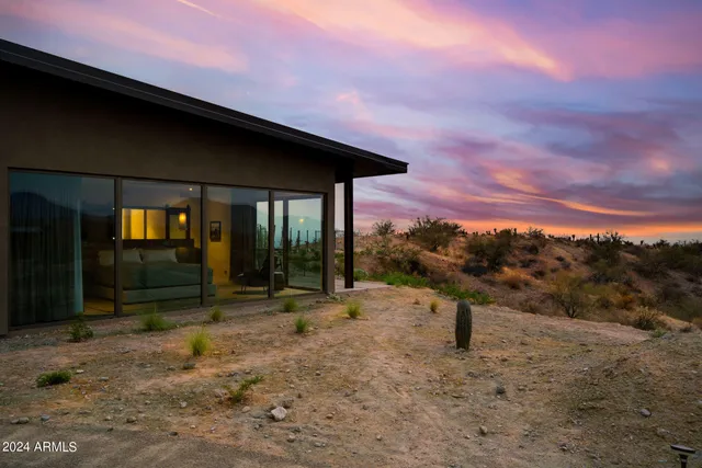 an aerial view of a house with a yard basket ball court and outdoor seating