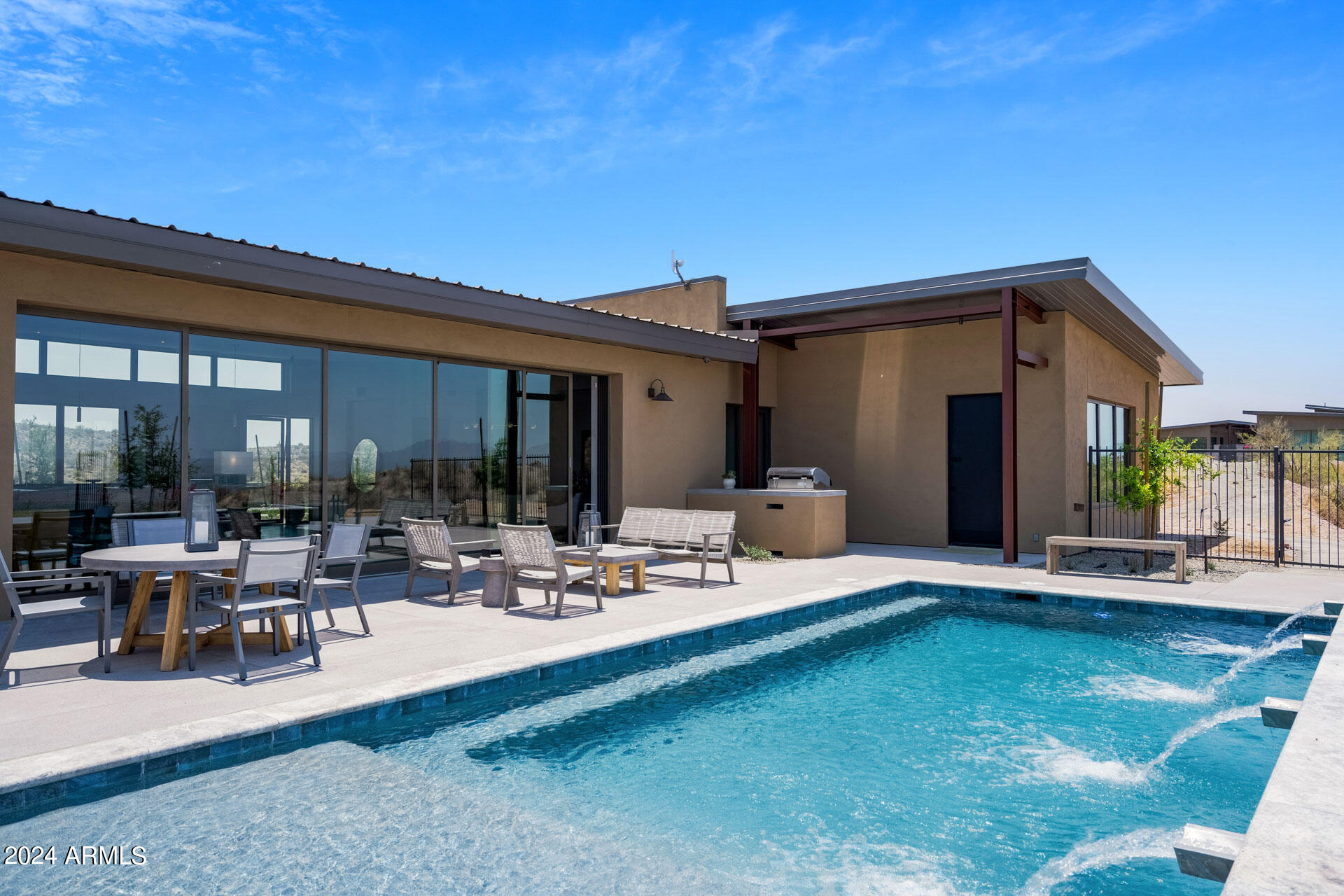 15322 North Sandy Blf Road Fort McDowell, AZ 85264 - Photo 44 of 65 a view of a patio with couches table and chairs under an umbrella with wooden floor