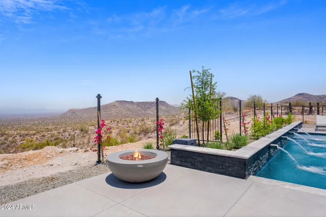 a view of a cafe with table and chairs under an umbrella
