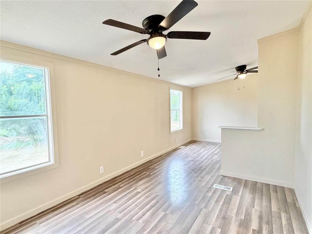 9721 Limestone Joshua, TX 76058 - Photo 31 of 36 a view of an empty room with wooden floor and a window