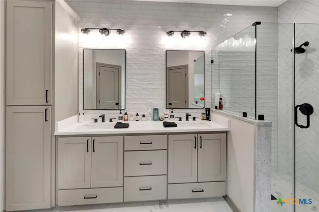 a bathroom with a double vanity sink and mirror