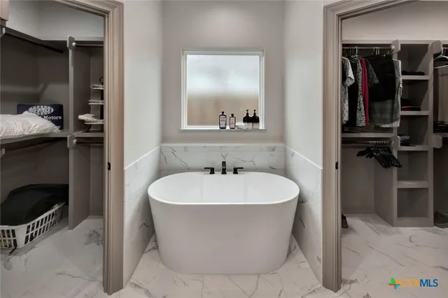 a white bath tub sitting in a bathroom
