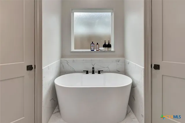 a white bath tub sitting in a bathroom