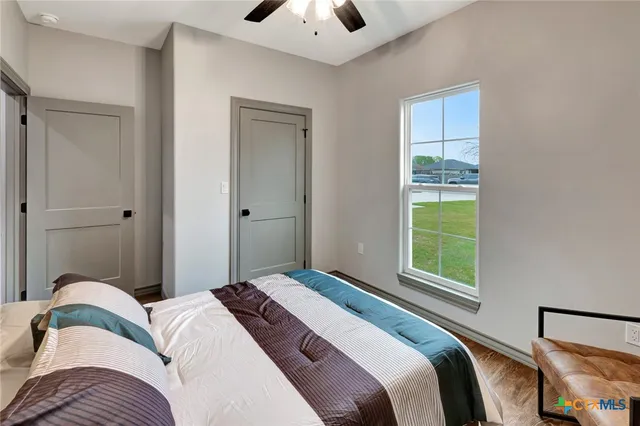 a bedroom with a bed and a window