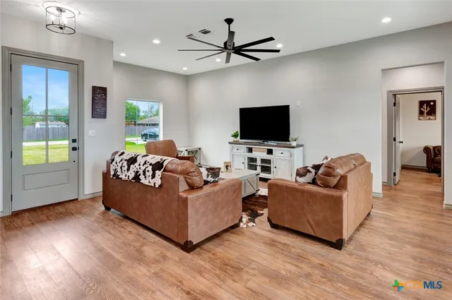 a living room with fireplace furniture and a flat screen tv