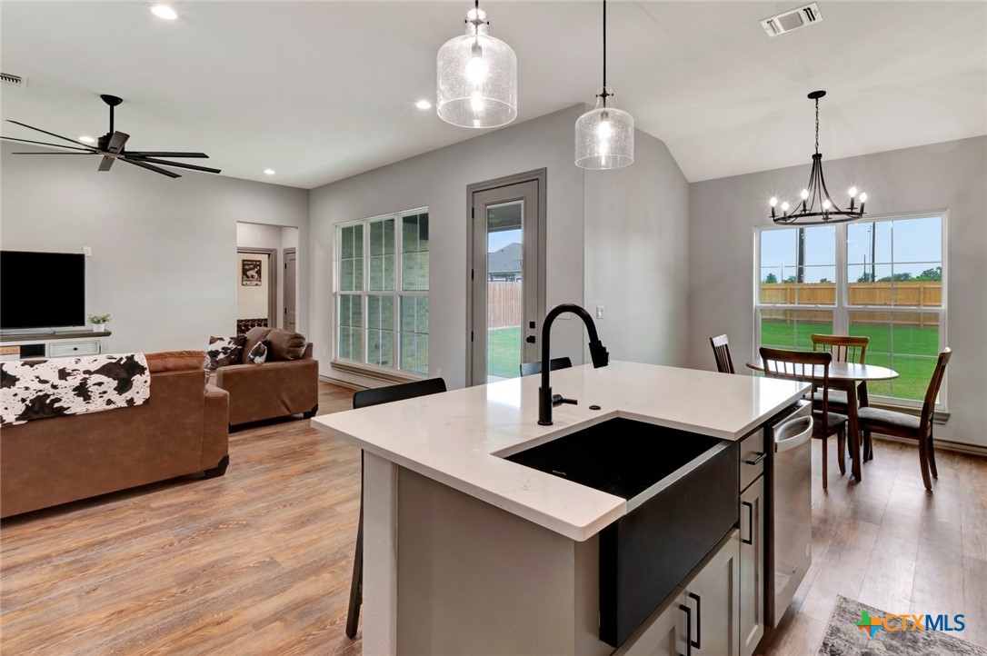 305 Turkey Lane Victoria, TX 77905 - Photo 8 of 35 a view of a dining room with furniture a chandelier and wooden floor