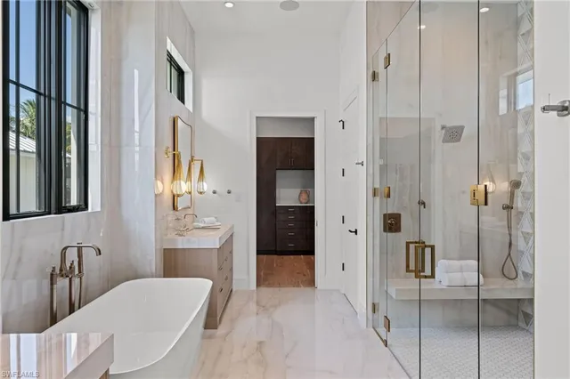 a bathroom with a granite countertop sink mirror and shower
