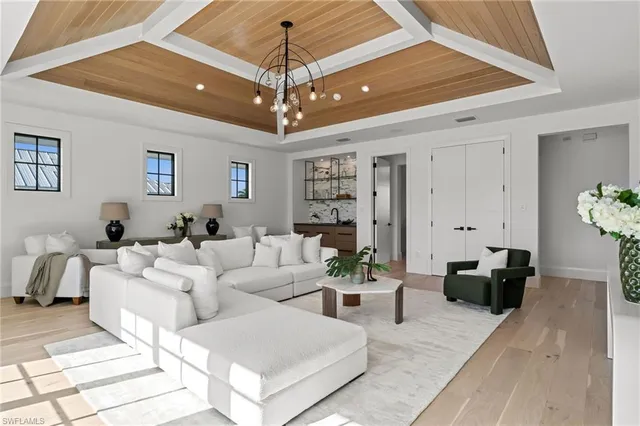 a living room with furniture and a chandelier