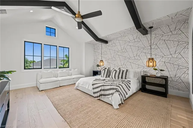 a bedroom with a bed a couch and a window