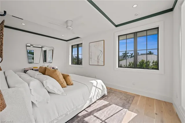 a bedroom with a bed a mirror and a window