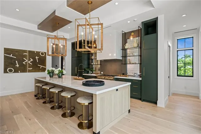 a kitchen with stainless steel appliances a sink stove and refrigerator