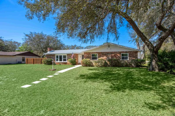 a front view of house with yard and green space