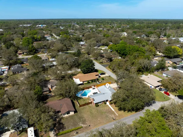 a view of a house with a backyard