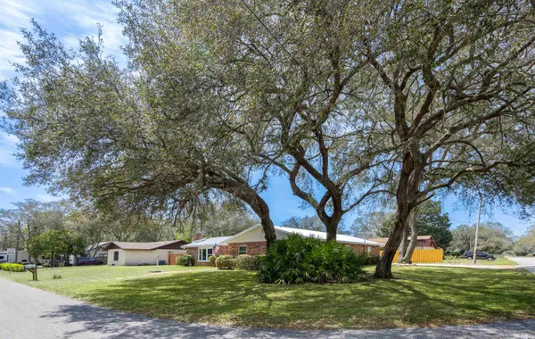 a living room with furniture and a dining table with wooden floor