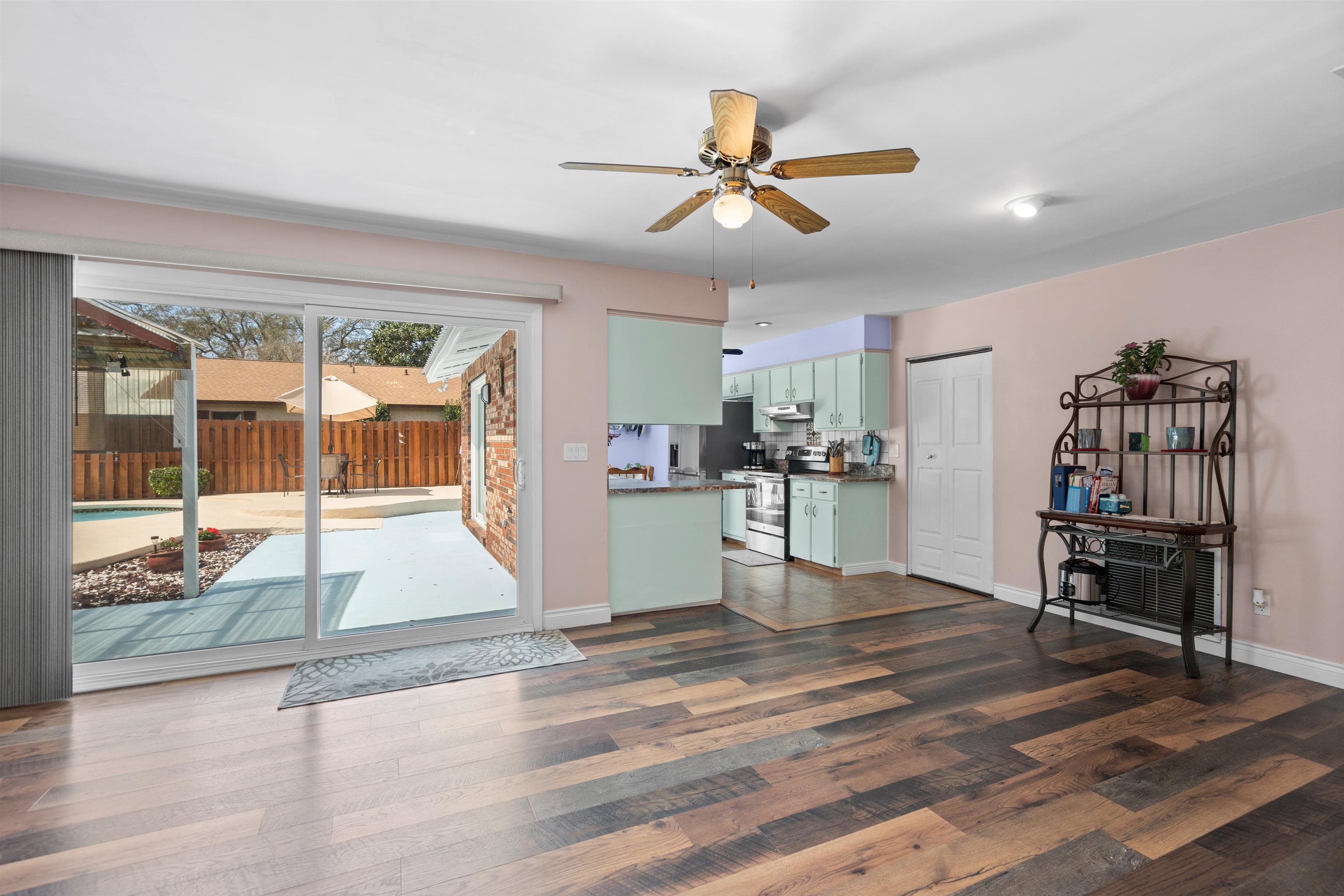 702 Queen Road St. Augustine, FL 32086 - Photo 29 of 71 a view of a livingroom with wooden floor and a ceiling fan