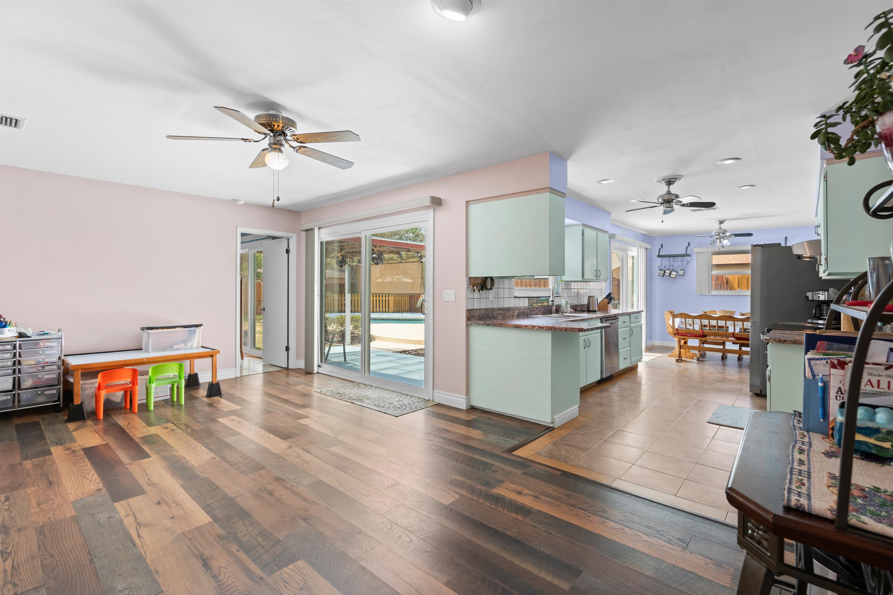 702 Queen Road St. Augustine, FL 32086 - Photo 30 of 71 a living room with furniture and a dining table with wooden floor