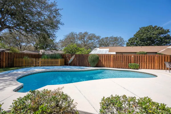 a view of a backyard with a table and chairs