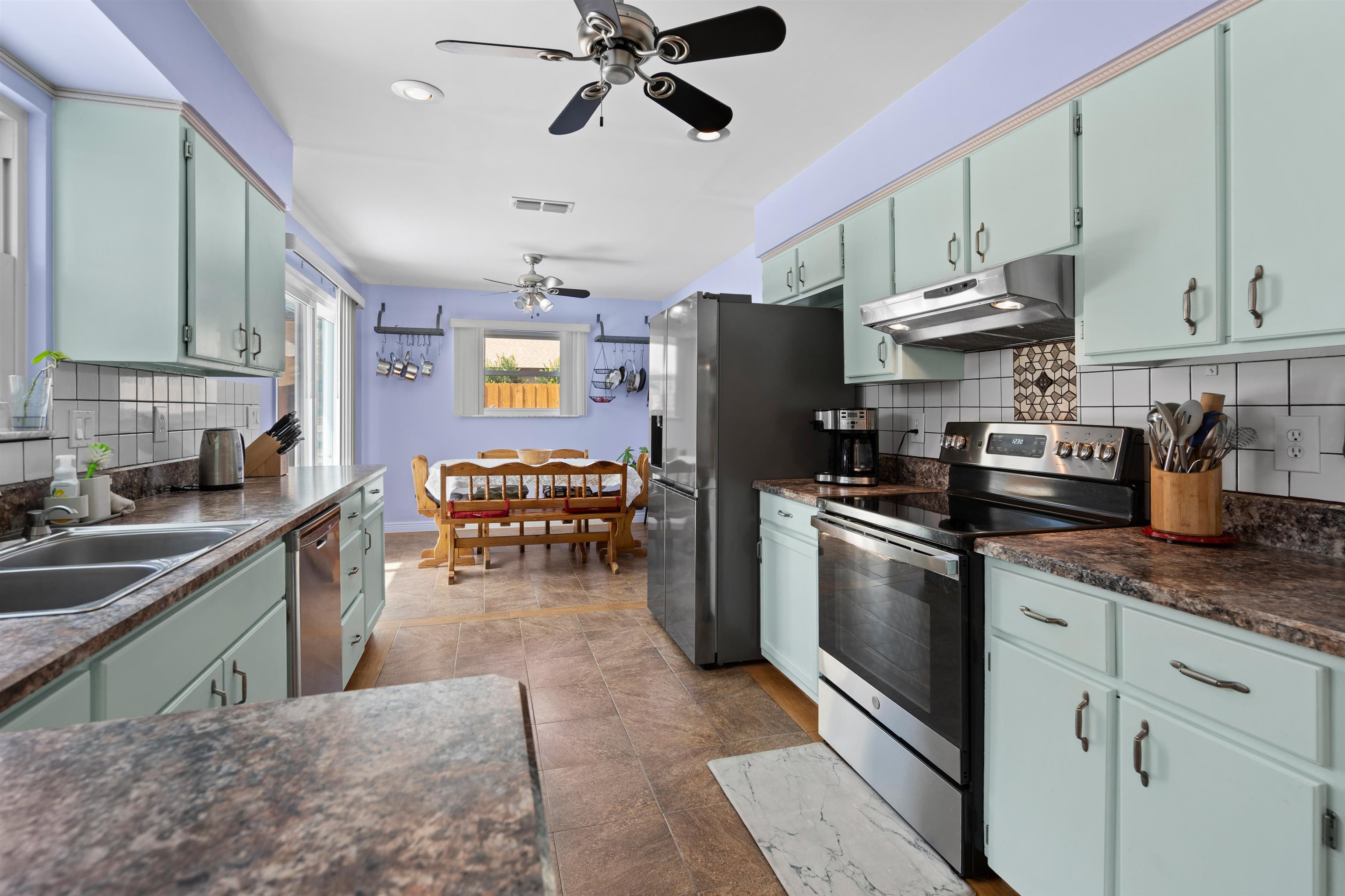 702 Queen Road St. Augustine, FL 32086 - Photo 32 of 71 a kitchen with stainless steel appliances granite countertop a sink a stove and a refrigerator