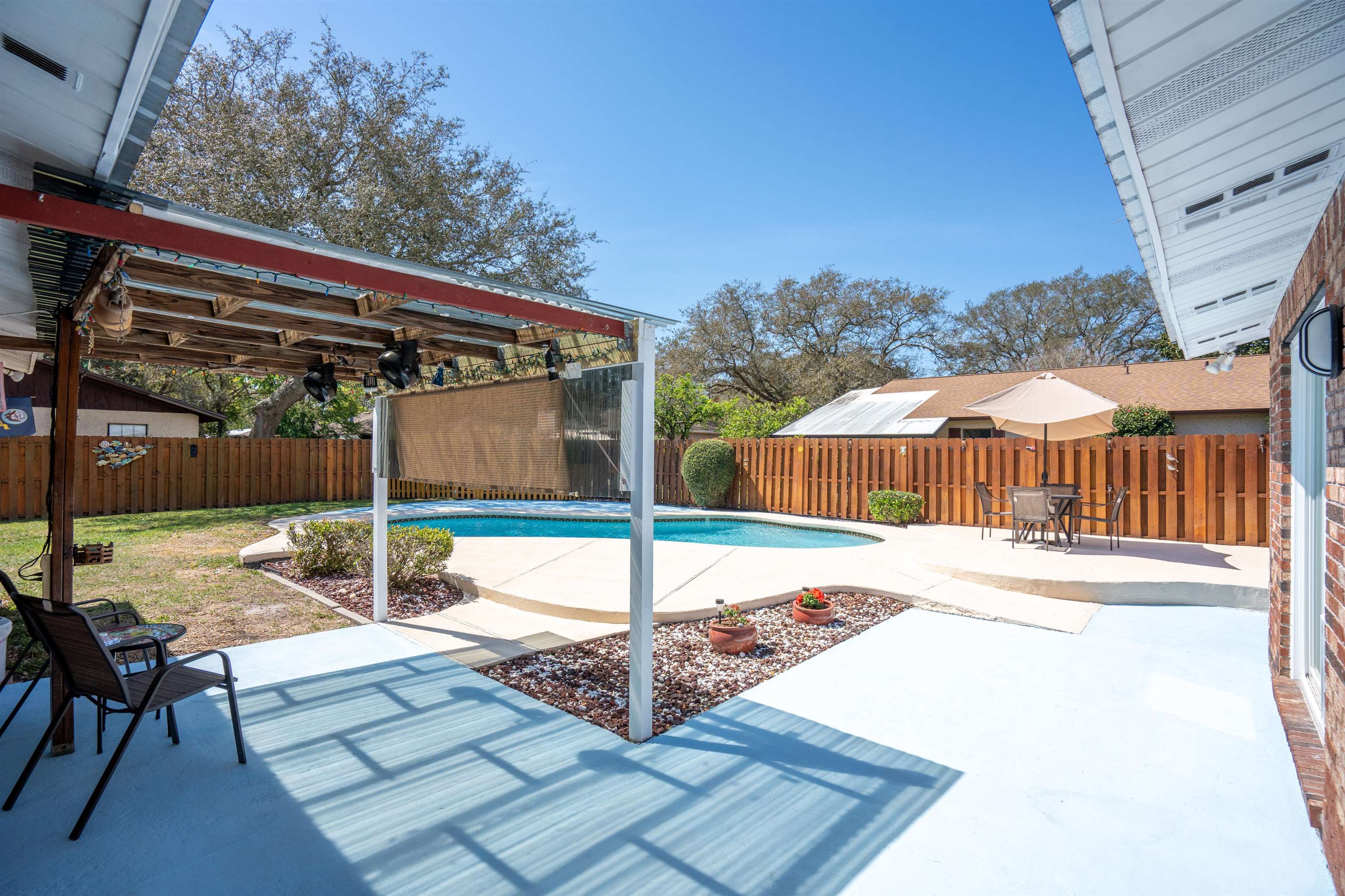 702 Queen Road St. Augustine, FL 32086 - Photo 4 of 71 a view of a backyard with a table and chairs