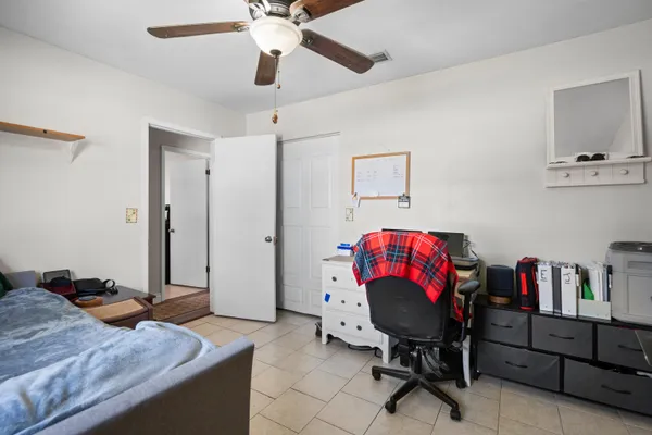 a view of a chair and table in the patio with a small yard