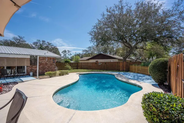 a view of a house with backyard and sitting area