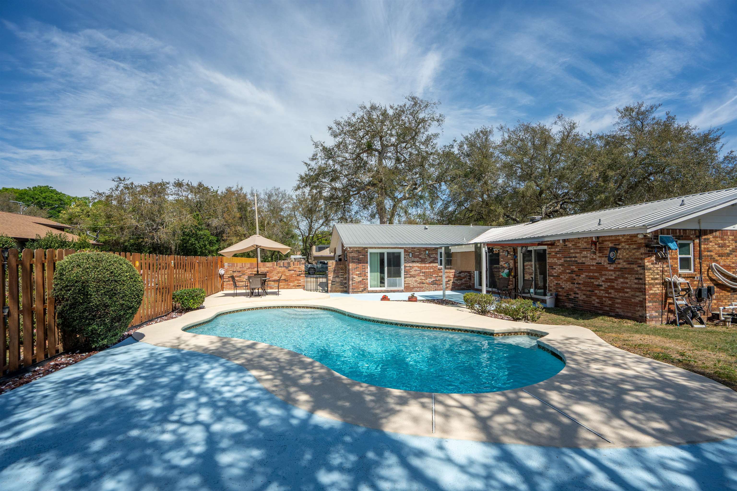 702 Queen Road St. Augustine, FL 32086 - Photo 10 of 71 a view of a house with swimming pool and a yard