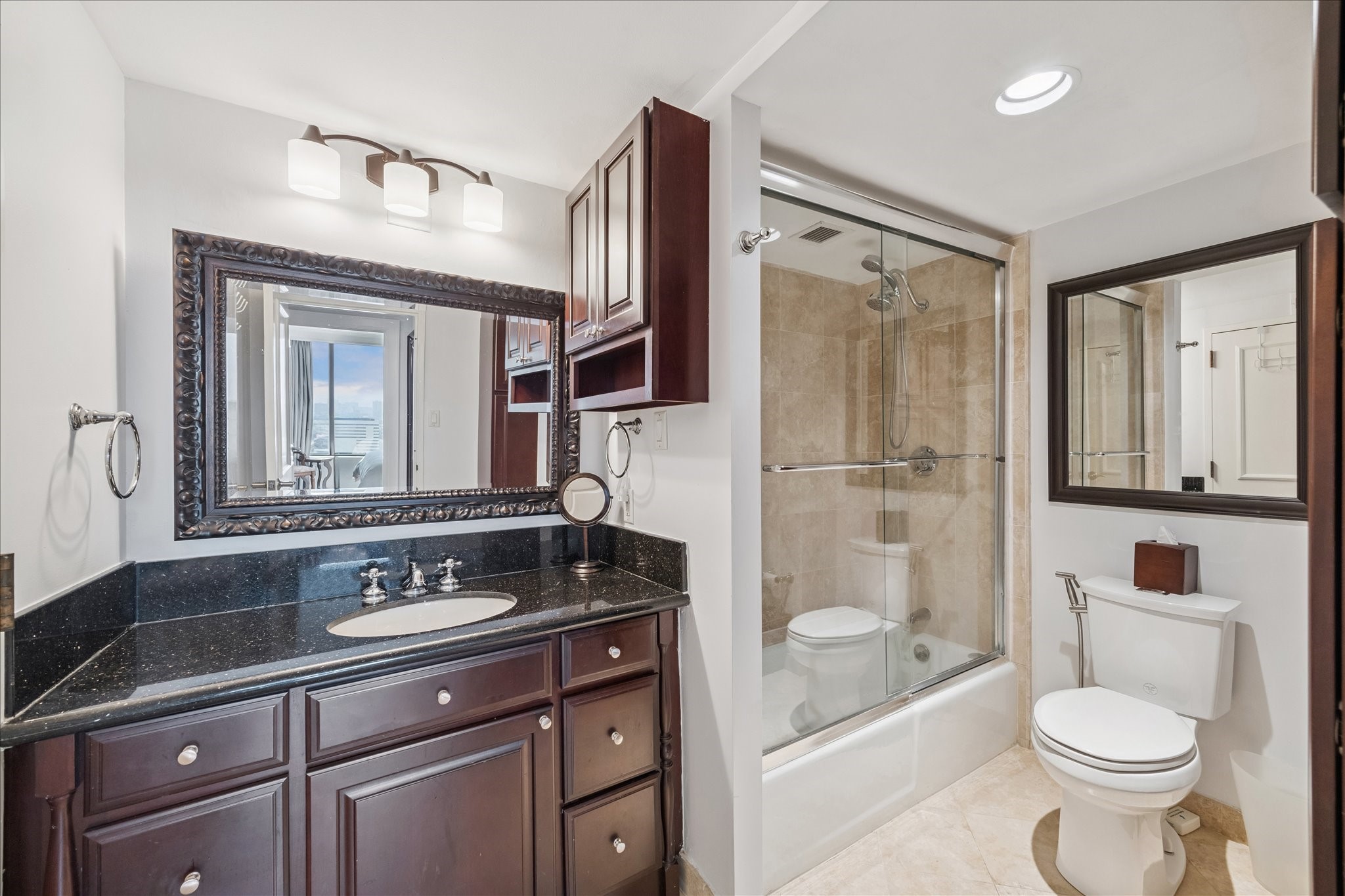 1111 Caroline Street, Unit 2908 Houston, TX 77010 - Photo 13 of 50 a bathroom with a sink a toilet a mirror and shower